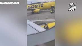 Worker taping Spirit Airlines plane wing goes viral as social media baffled | New York Post